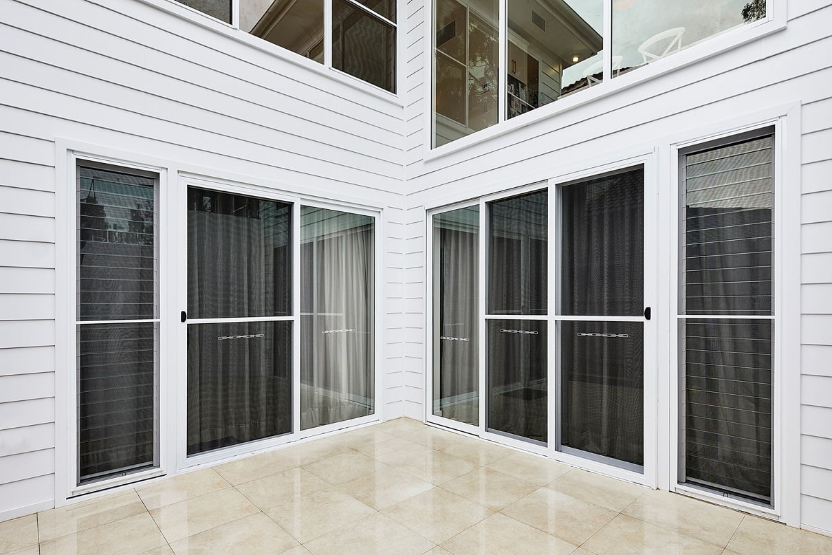 Ascend sliding & stacking doors, louvre window in Pearl White, in clad home