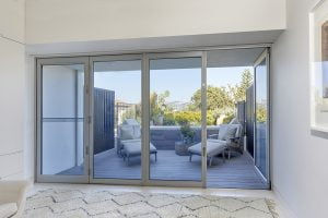 Paragon bi-fold door and sashless window in clear anodised finish