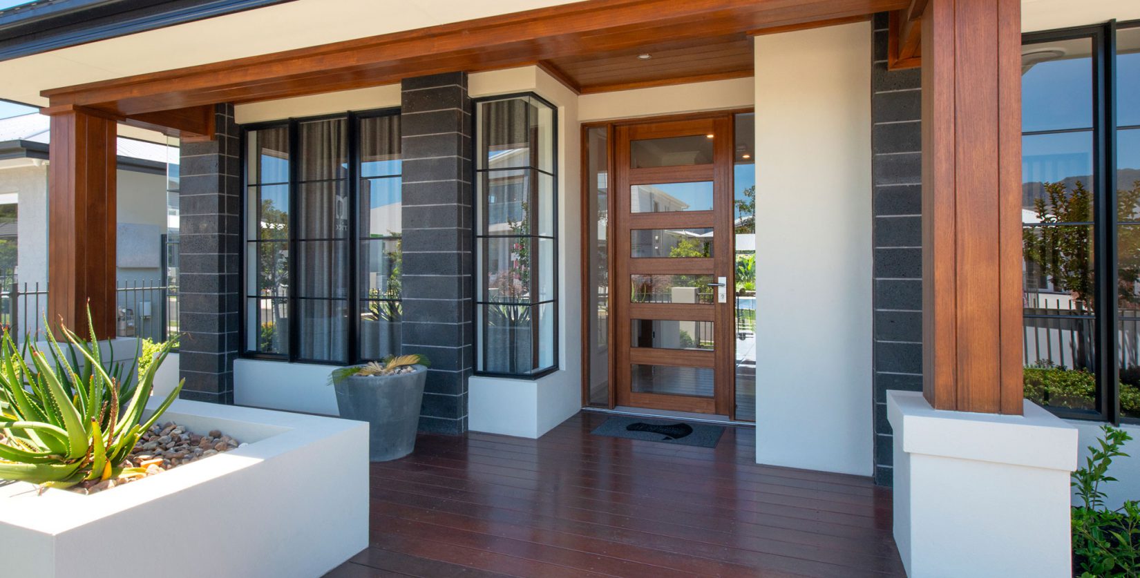Natura timber entry door and sidelites with Horizon awning windows