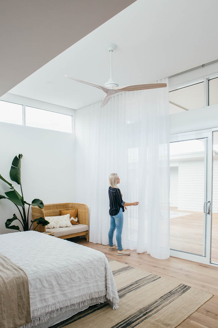 Woman closing curtain on sliding doors
