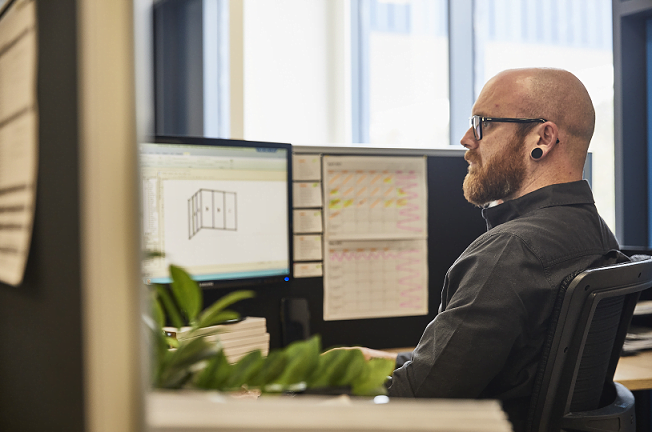Bald man sat in office at desk