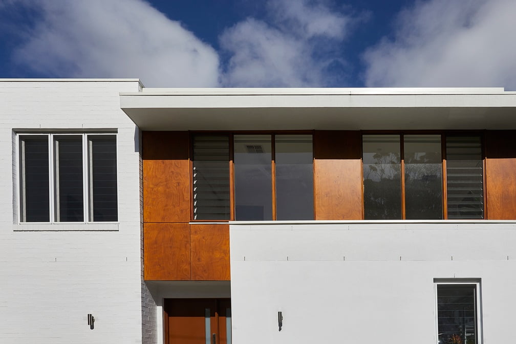 Timber louvre windows on white house